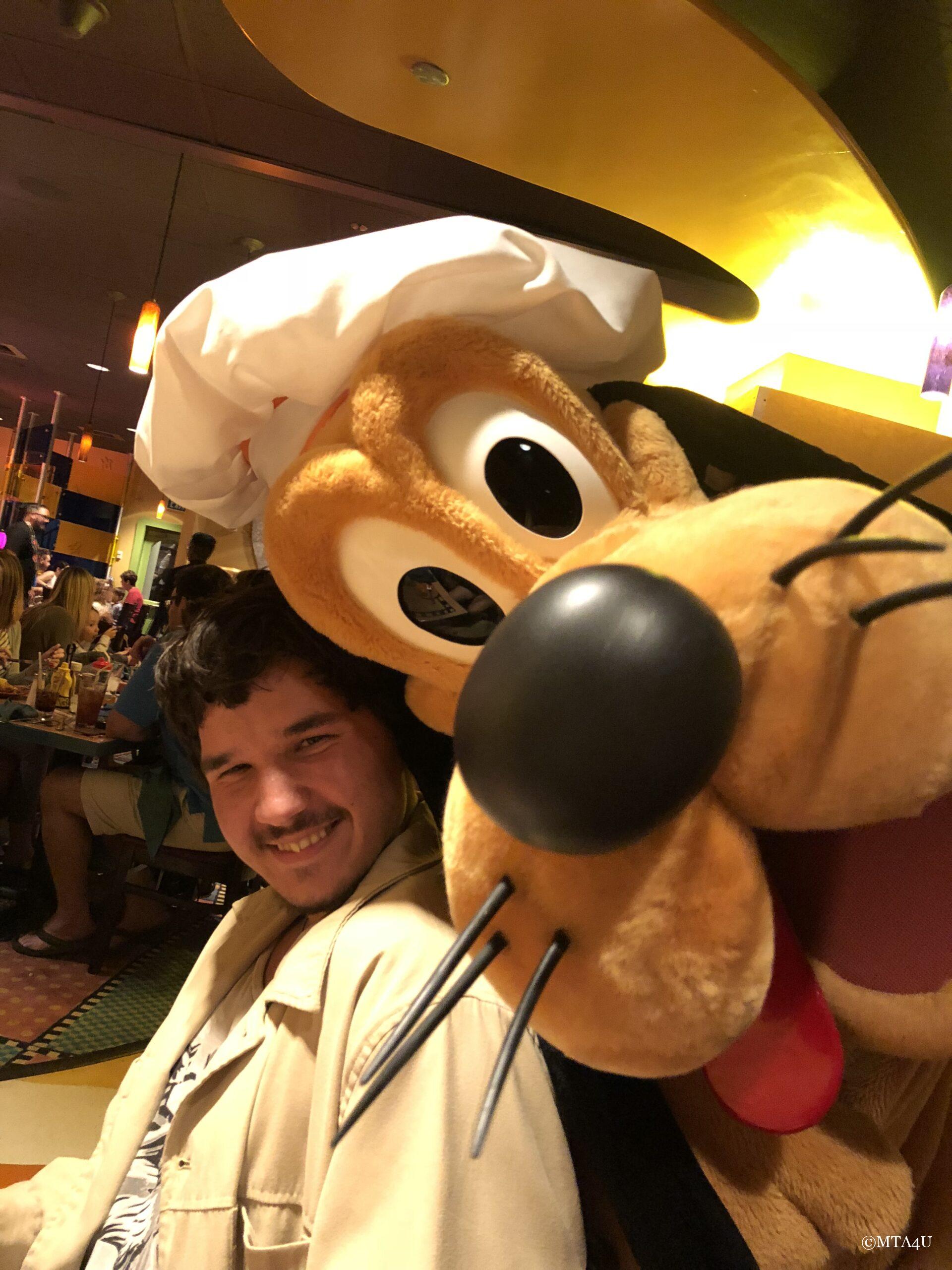 MTA4U family member with Pluto at Goofy's Kitchen in Disneyland having fun.
