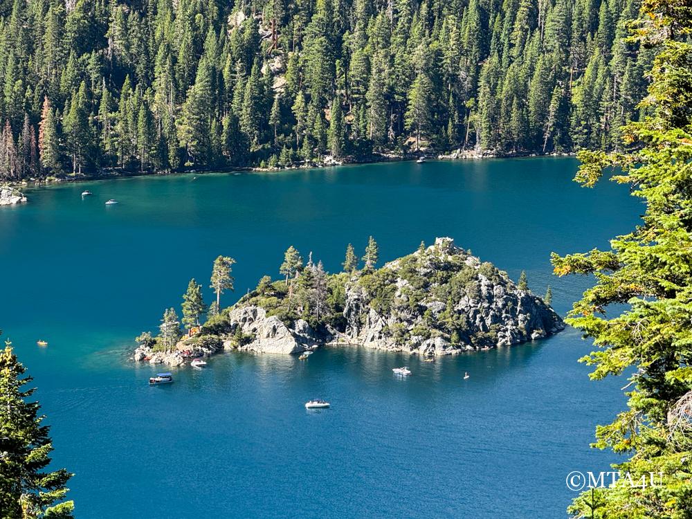 View of. Emerald Bay from Inspiration Point of Lake Tahoe, showcasing the deep blue water, Fannette Island, and surrounding evergreen trees.