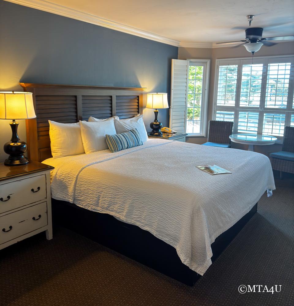 Cozy guest room at Sand Pebbles Inn with a king-sized bed and warm lighting.