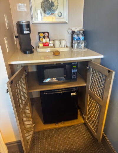 Guest room amenities at Sand Pebbles Inn, including a mini-fridge and microwave.