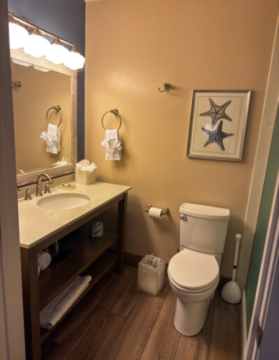 Bathroom in a guest room at Sand Pebbles Inn with beach-inspired decor.