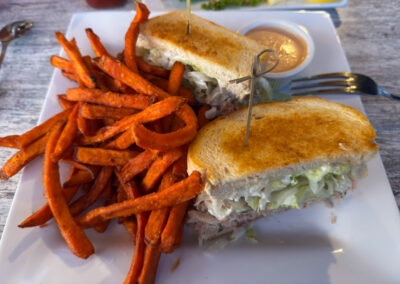 A seafood sandwich served with sweet potato fries at Moonstone Bar and Grill in Cambria, California.