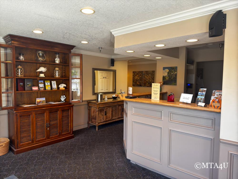 Lobby area of Sand Pebbles Inn with warm, welcoming decor in Cambria, California.