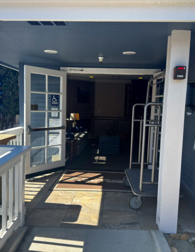 Entrance to Sand Pebbles Inn in Cambria, California, featuring an open and welcoming pathway.