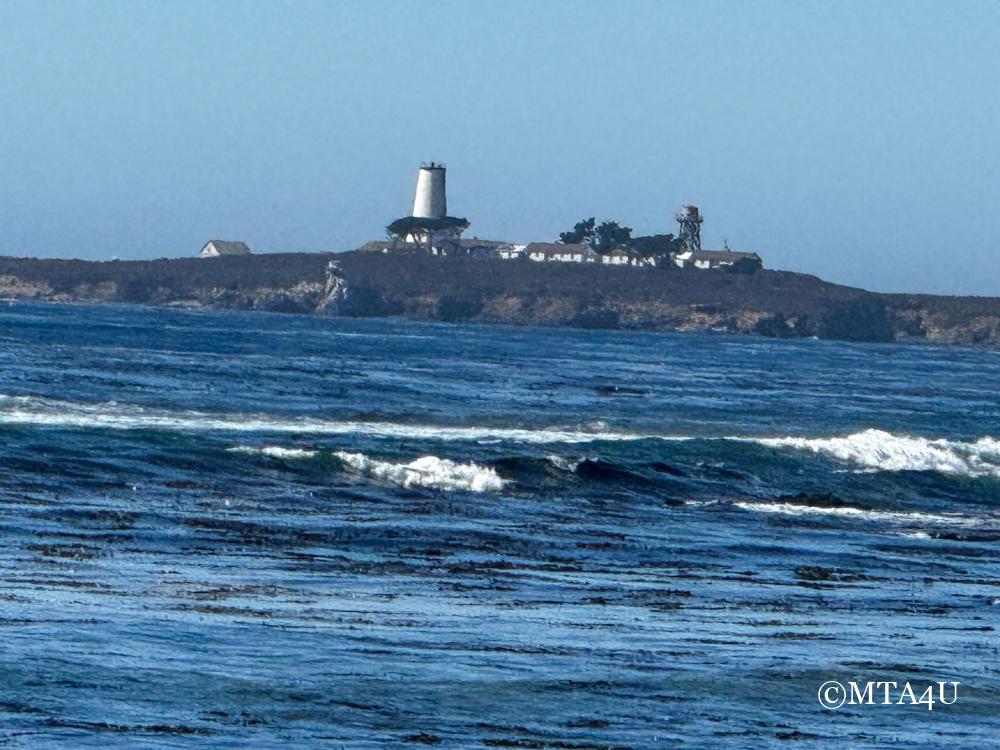 A distant view of the Piedras Blancas Lighthouse along Highway 1 near San Simeon, California.