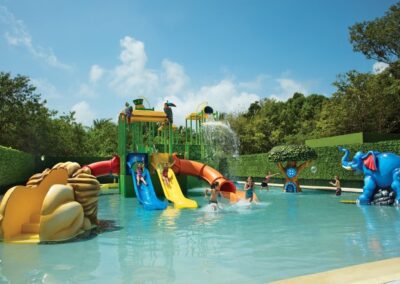 Children playing at the splash zone and water slides at Dreams Tulum Resort.