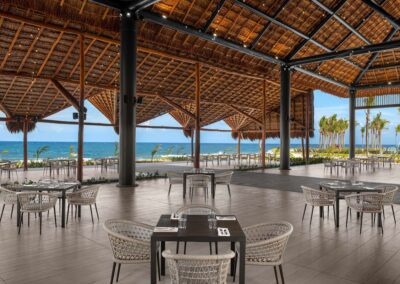 Open-air beachfront dining space at a family-friendly Tulum resort.
