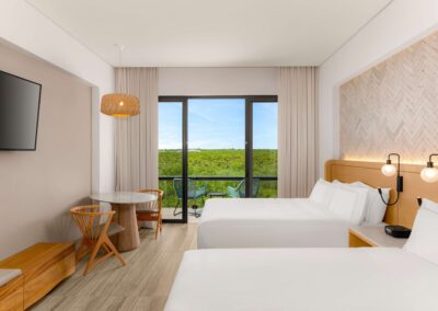 Modern family suite with two queen beds and a private balcony in Tulum.
