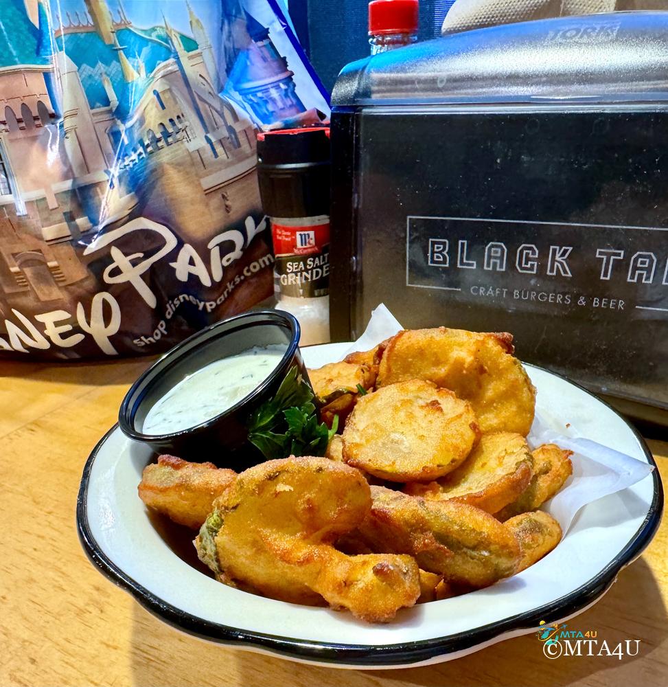 Black Tap Anaheim Fried Pickles with Ranch A plate of crispy fried pickles served with ranch dressing at Black Tap Anaheim, located in the Downtown Disney District.