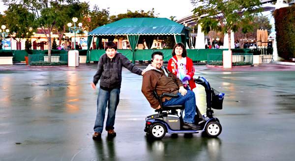 Illya-and-Kids-First-Disneyland-Trip Illya using scooter rentals for Disneyland during our first family trip.