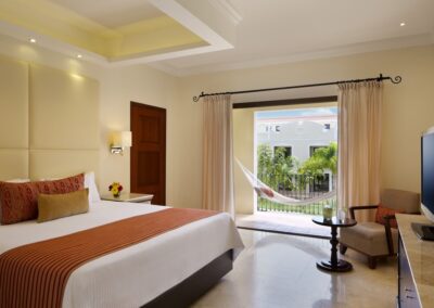 King suite at Dreams Tulum Resort with hammock on private balcony.