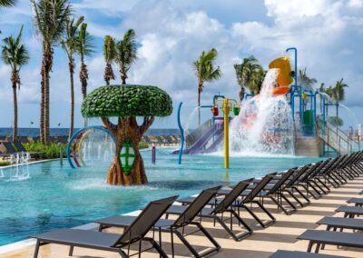 Outdoor splash zone with waterslides and splash features for kids.