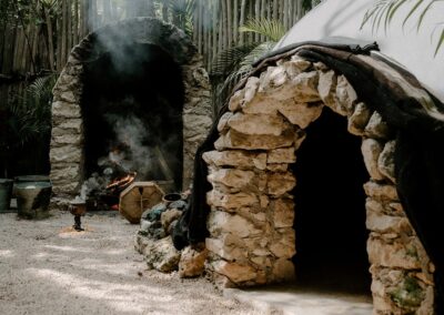 Stone-built temazcal and fire pit used in traditional wellness ceremonies.