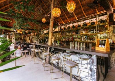 Jungle Bar Lounge with Tree-Integrated Design and Ambient Lighting.