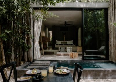 Intimate jungle suite with private plunge pool and outdoor dining setup.