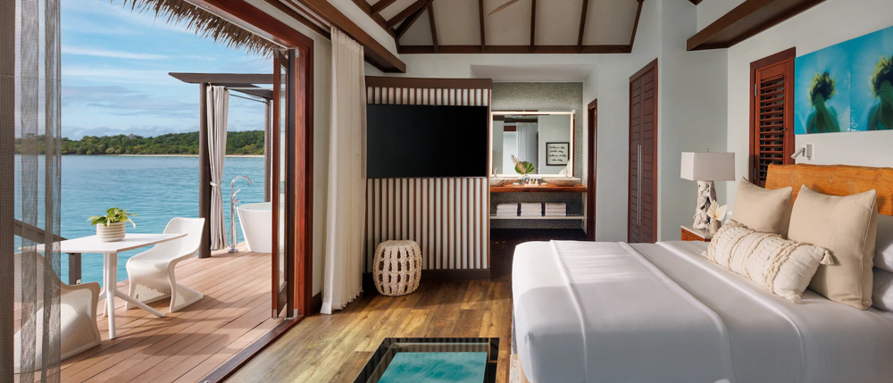 Inside an Over-the-Water Bungalow Interior of an over-the-water bungalow at Sandals South Coast with ocean view and private deck.