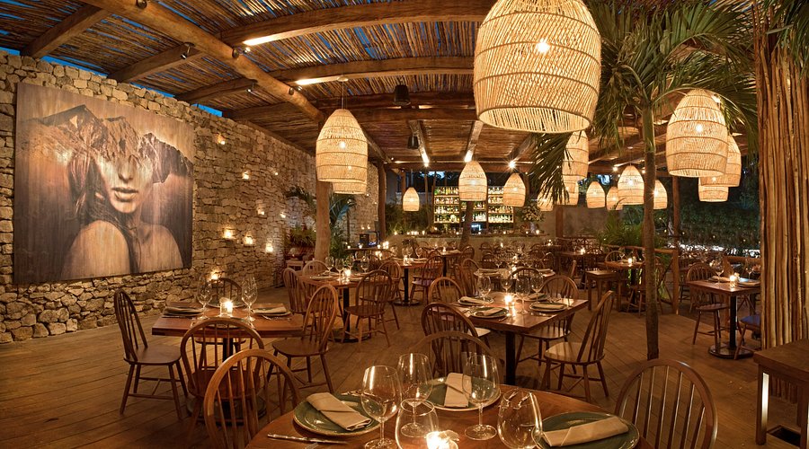Rosa Negra Tulum Jungle Dining Romantic jungle dining setup at Rosa Negra Tulum with candlelit tables and warm lighting.