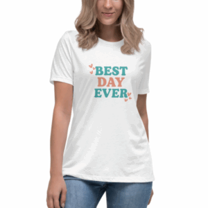 Woman standing and smiling in a white Best Day Ever t-shirt with colorful text and heart accents.