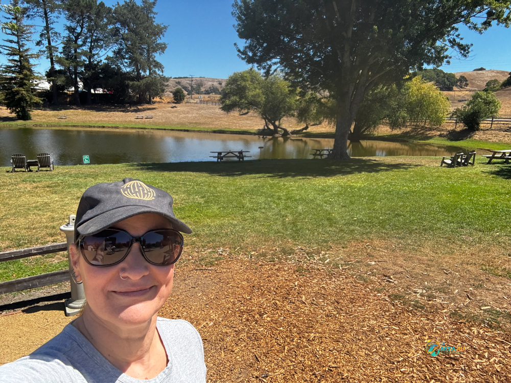 Traveler standing by the pond at Marin Cheese Factory in California during a Point Reyes day trip itinerary.