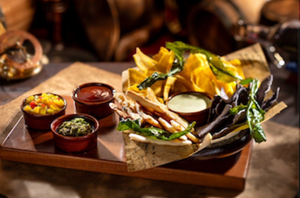 Island Provisions dish at The Beak and Barrel with plantain chips, tortillas, flatbread, and Caribbean-inspired dips.