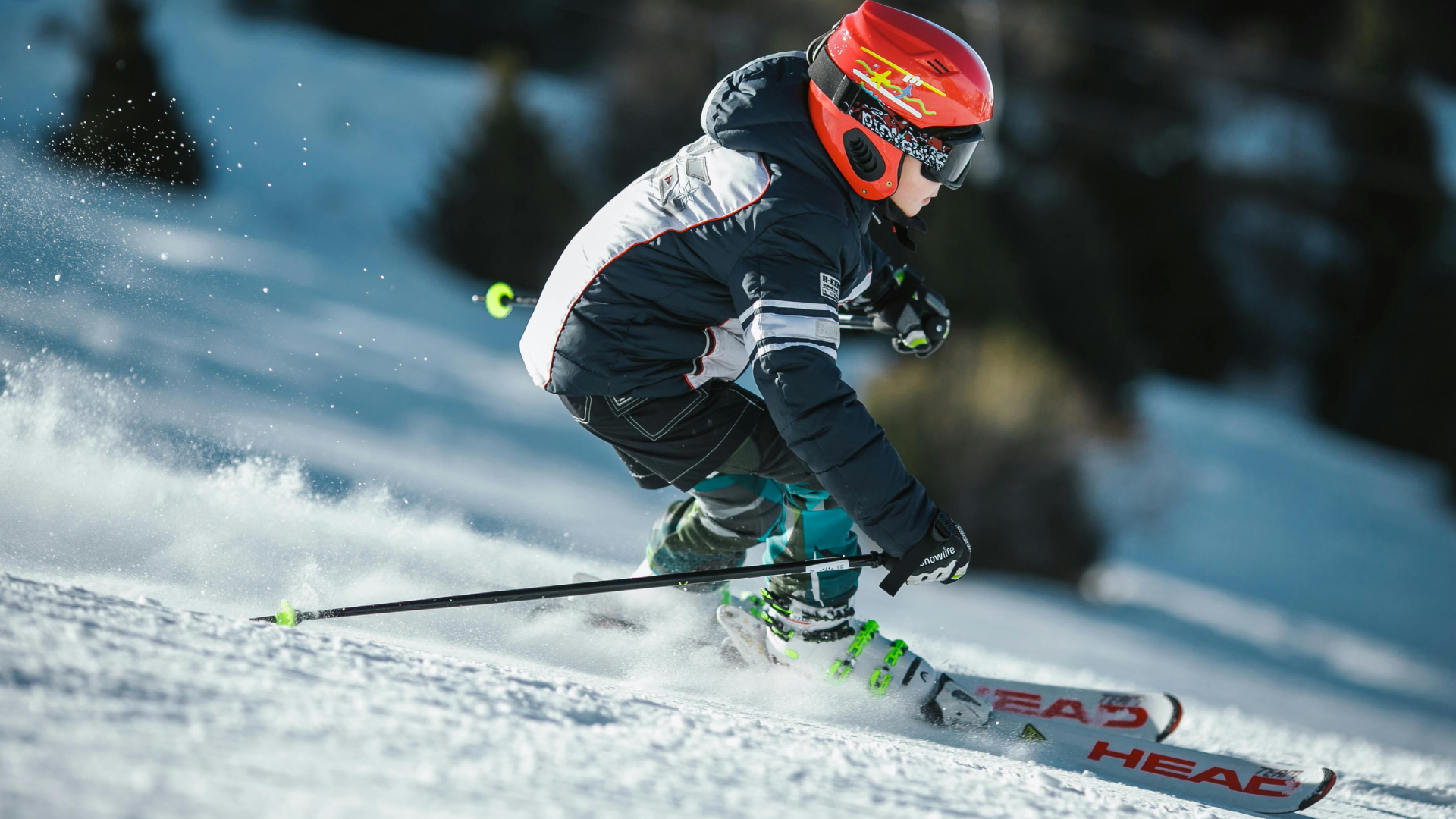 Child skiing downhill on a snowy mountain during an adventure-focused winter getaway.