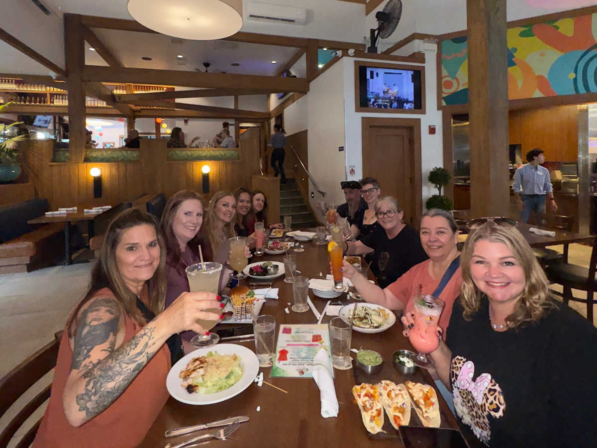 Noel Chapman enjoying dinner with her travel business team, celebrating community and connection.