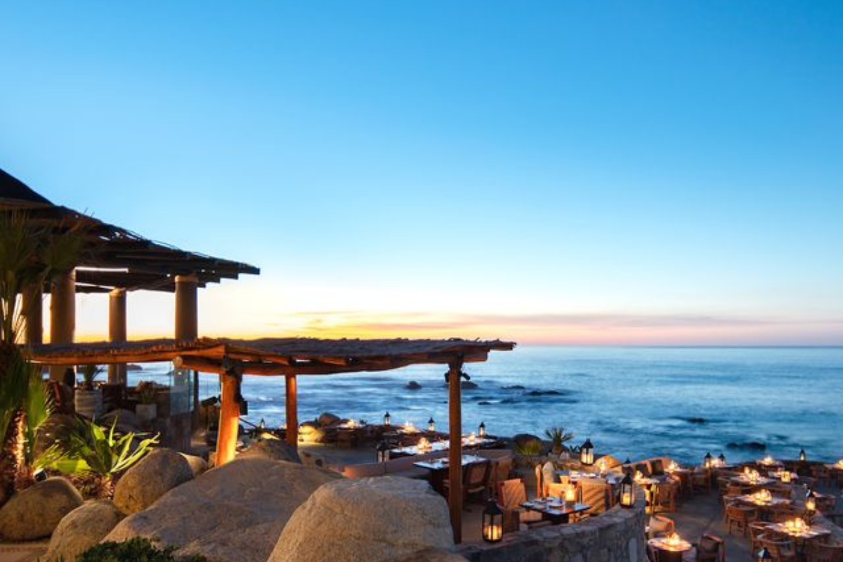 Oceanfront dining at Cocina del Mar in Los Cabos with candlelit tables overlooking the Sea of Cortez.