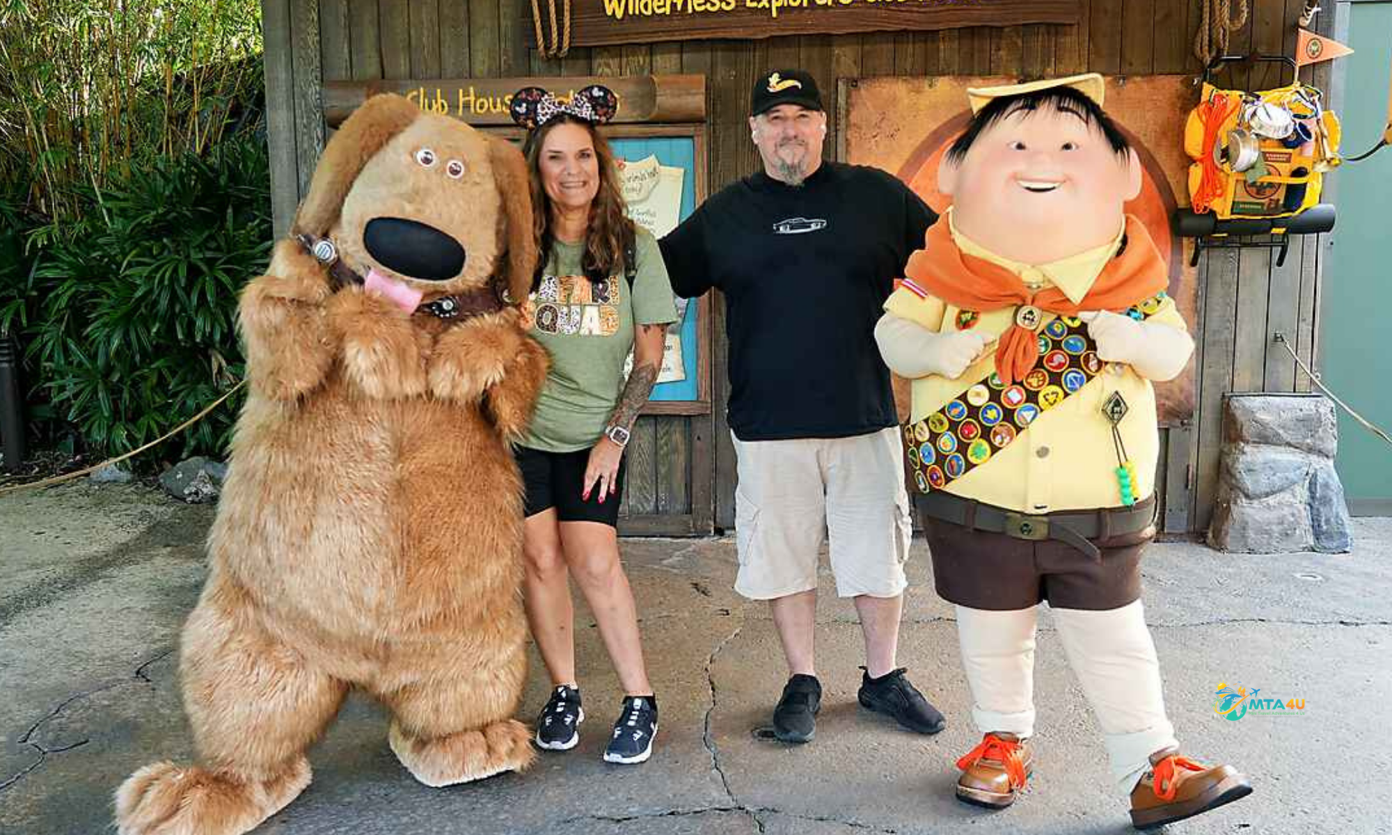 Noel Chapman with Dug and Russell characters at Disney’s Wilderness Explorers Clubhouse.