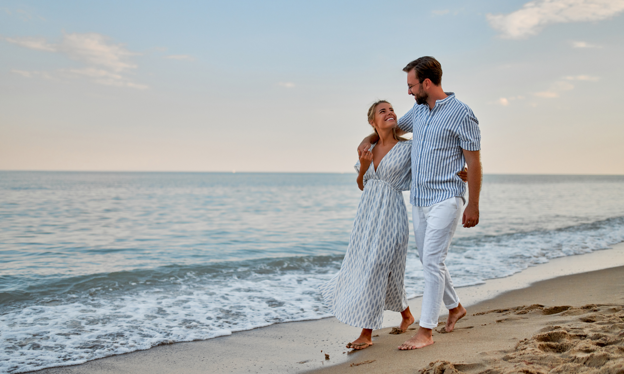 Couple walking along the beach in Los Cabos, Mexico.
