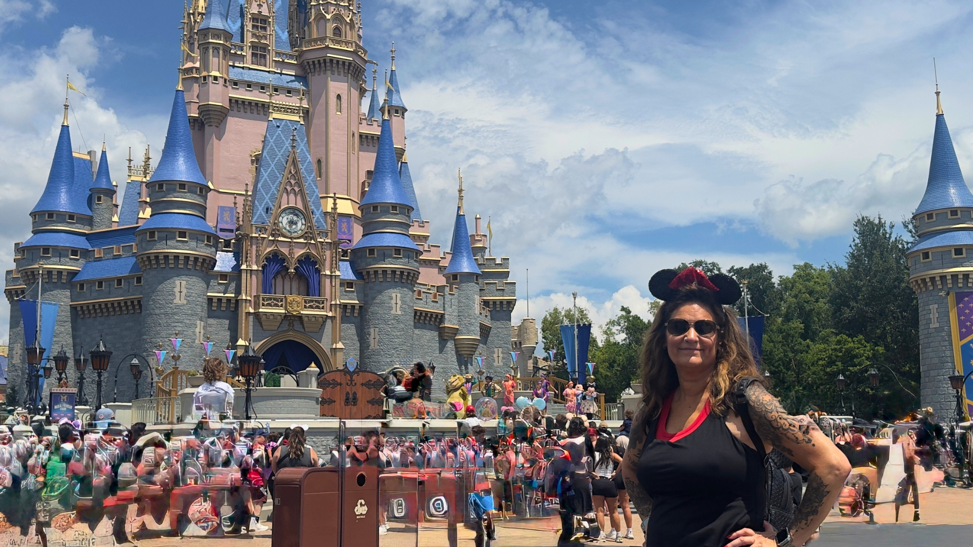 Disney travel advisor Noel Chapman in front of Cinderella Castle at Walt Disney World.