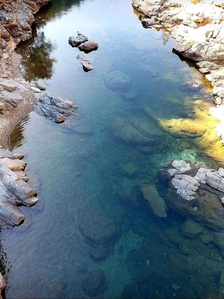Clear emerald swimming hole on the South Yuba River, seen from above