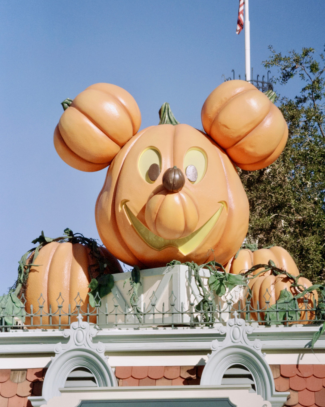 Mickey Mouse pumpkin decoration above the entrance at Disneyland during the Halloween season.