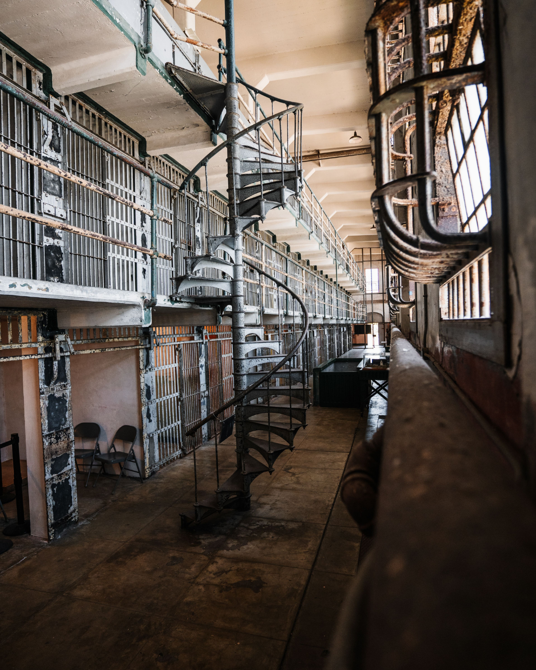 Cell block row and spiral staircase inside the Alcatraz cellhouse.